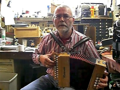 Noud Martinali - in zijn werkplaats - speelt 30 februari op een van zijn harmonicas, een in BesEs gestemd exemplaar.